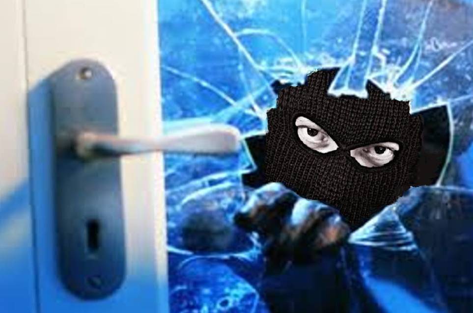 Burglar breaking into a home